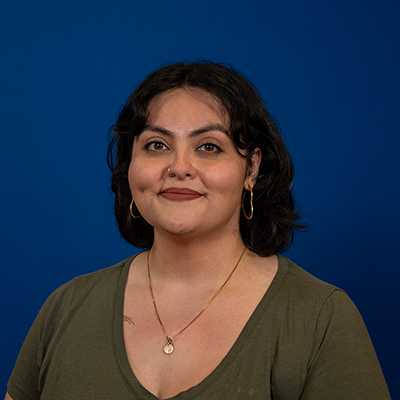 A Latina woman in her 30s with short dark hair.