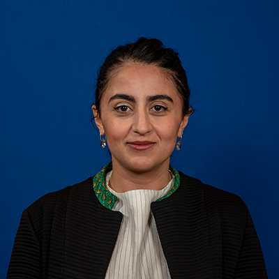 A Middle Eastern woman in her 30s with long dark hair.